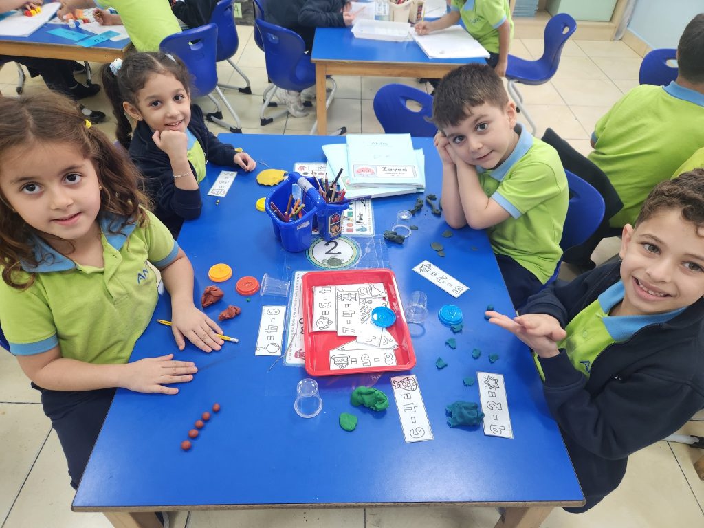 Students using real materials to build and count